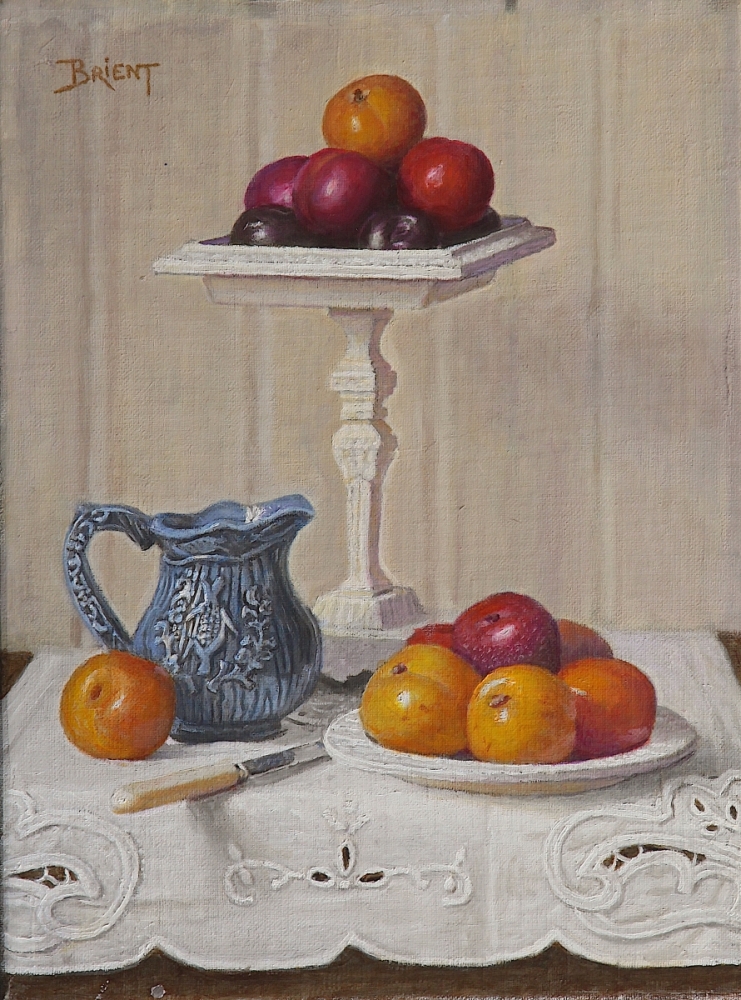 A compotier with plums, a plate of plums, a small blue pitcher