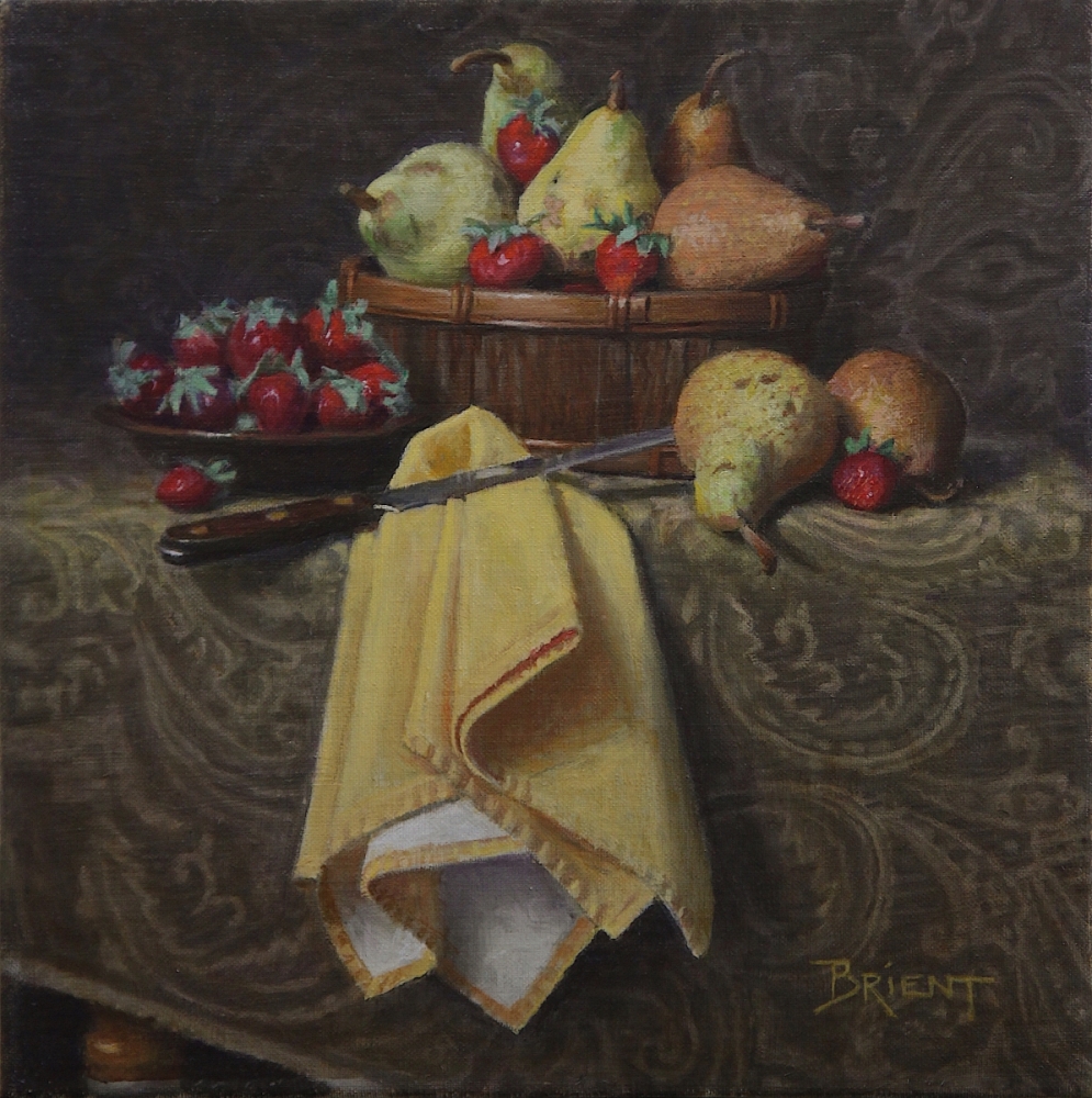 Basket of pears and strawberries, a plate of strawberries, a large yellow napkin, on a pattern fabric