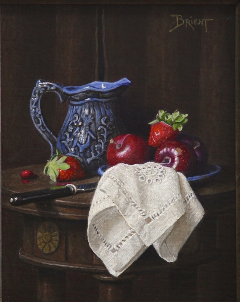 A little blue jug with red fruits  