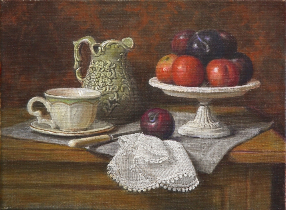 A small green pitcher with a plate of plums and a cup  