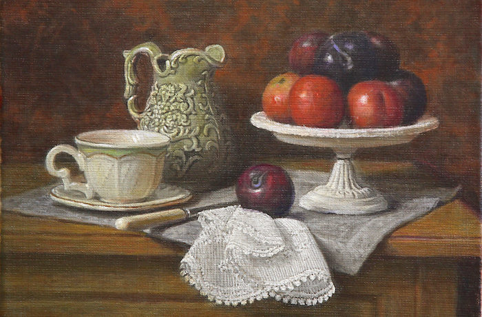 A Green jug and a plate of plums